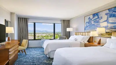 a hotel room with two beds and a large window at The Westin Westminster in Westminster
