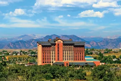 a large hotel building with mountains in the background at The Westin Westminster in Westminster
