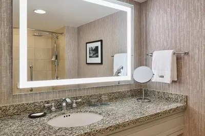 a bathroom with a sink and a large mirror at The Westin Westminster in Westminster