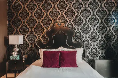a bedroom with a large bed with red pillows at Ember Hostel in Denver