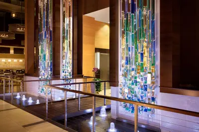 a lobby with colorful glass sculptures on the wall at Embassy Suites by Hilton Denver Downtown Convention Center in Denver