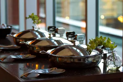 three copper pans sitting on a table with spoons at Embassy Suites by Hilton Denver Downtown Convention Center in Denver