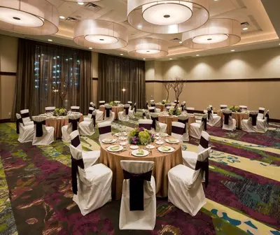 a conference room with tables and chairs in a room at Embassy Suites by Hilton Denver Downtown Convention Center in Denver