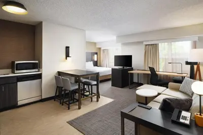 a hotel room with a bed and a living room at Residence Inn Boulder Longmont in Longmont