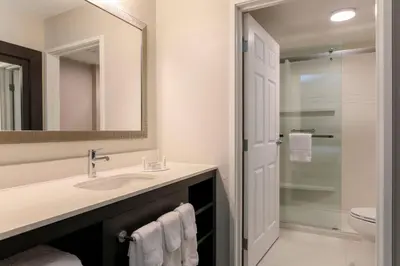 a bathroom with a sink and a toilet and a mirror at Residence Inn Boulder Longmont in Longmont