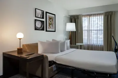 a hotel room with a large bed and a couch at Residence Inn by Marriott Boulder Broomfield in Louisville
