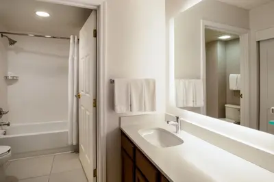 a white bathroom with a sink and a mirror at Residence Inn by Marriott Boulder Broomfield in Louisville
