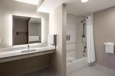a bathroom with a sink and a shower and a mirror at Residence Inn by Marriott Boulder Broomfield in Louisville