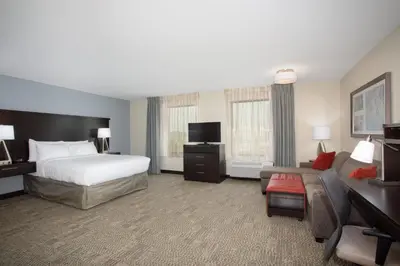 a hotel room with a bed and a couch at Staybridge Suites Denver South - Highlands Ranch by IHG in Littleton