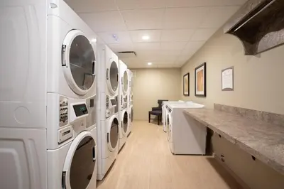 a laundry room with white washers and dryers at Staybridge Suites Denver South - Highlands Ranch by IHG in Littleton