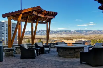 a patio with a table and chairs and a fire pit at Staybridge Suites Denver South - Highlands Ranch by IHG in Littleton