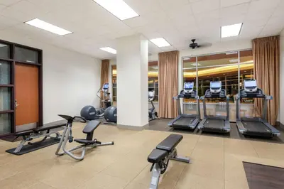 a gym with several treadmills and exercise bikes at Embassy Suites Loveland Conference Center in Loveland