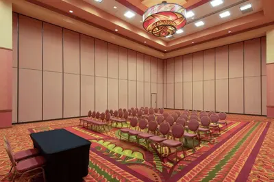 a conference room with chairs and a podium in it at Embassy Suites Loveland Conference Center in Loveland
