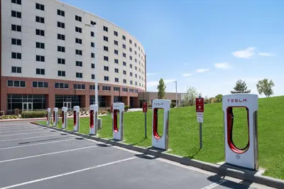 a row of red and white pay phones in a parking lot at Embassy Suites Loveland Conference Center in Loveland