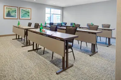 a conference room with tables and chairs with bottles on them at Residence Inn by Marriott Boulder Broomfield/Interlocken in Broomfield