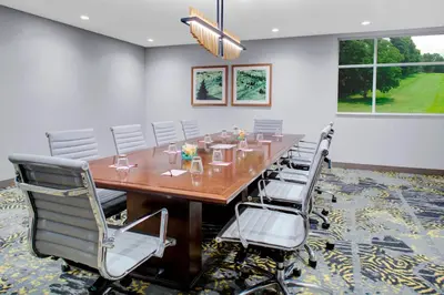 a conference room with a long wooden table and chairs at Residence Inn by Marriott Boulder Broomfield/Interlocken in Broomfield