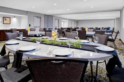 a conference room with tables and chairs with wine glasses at Residence Inn by Marriott Boulder Broomfield/Interlocken in Broomfield