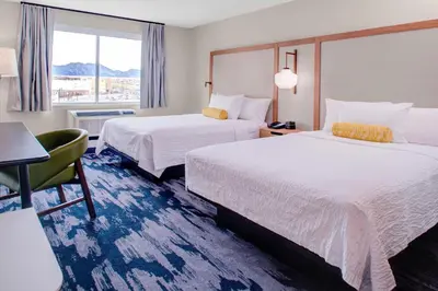 a hotel room with two beds and a window at Fairfield by Marriott Inn and Suites Boulder Broomfield Interlocken in Broomfield