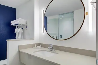 a bathroom with a sink and a mirror at Fairfield by Marriott Inn and Suites Boulder Broomfield Interlocken in Broomfield
