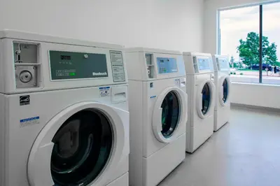 a row of washing machines in a laundry room at Fairfield by Marriott Inn and Suites Boulder Broomfield Interlocken in Broomfield