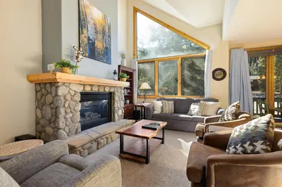 a living room with couches and a fireplace at 2985 Ironwood Townhomes in Keystone