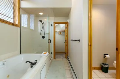a bathroom with a bath tub and a shower at 2985 Ironwood Townhomes in Keystone