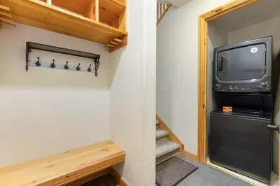 a room with a staircase and a tv at 2985 Ironwood Townhomes in Keystone