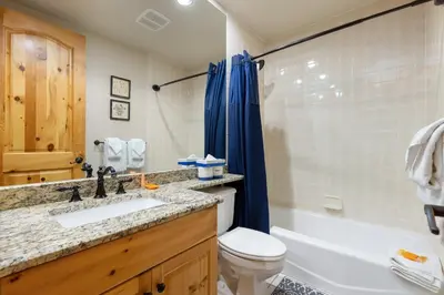 a bathroom with a sink and a toilet and a tub at 2985 Ironwood Townhomes in Keystone
