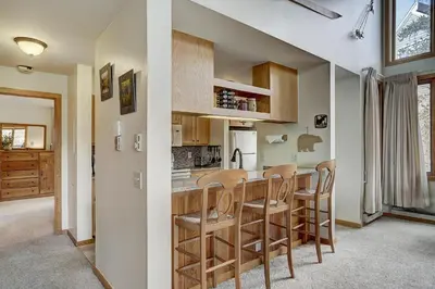 a kitchen and dining room with a table and chairs at 2072 The Pines Condo in Keystone