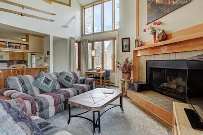 a living room with a couch and a fireplace at 2072 The Pines Condo in Keystone