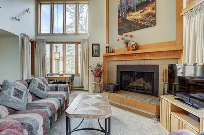 a living room with a couch and a fireplace at 2072 The Pines Condo in Keystone