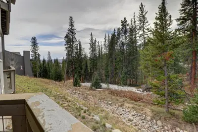 a view from the balcony of a house with trees at A5 Gore Trail Condo in Silverthorne