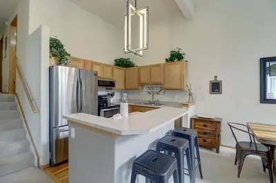 a kitchen with a refrigerator and a table and chairs at A5 Gore Trail Condo in Silverthorne