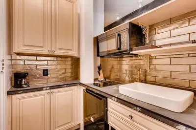 a kitchen with a sink and a counter at The Holiday Chalet Victorian in Denver
