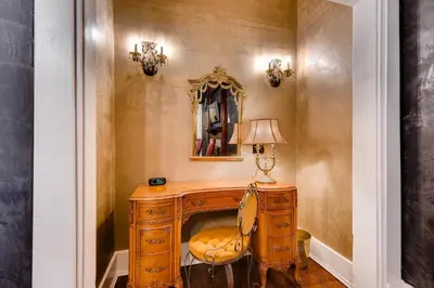 a room with a desk with a mirror and a chair at The Holiday Chalet Victorian in Denver