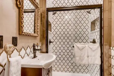 a bathroom with a sink and a shower at The Holiday Chalet Victorian in Denver