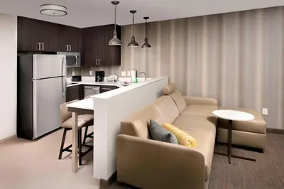 a living room and kitchen with a couch and a table at Residence Inn by Marriott Denver Airport/Convention Center in Denver