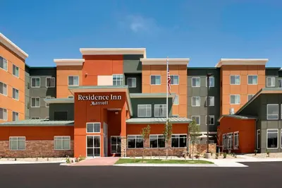 a red brick building with an american flag in front at Residence Inn by Marriott Denver Airport/Convention Center in Denver