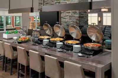 a buffet in a restaurant with many food at Residence Inn by Marriott Denver Airport/Convention Center in Denver