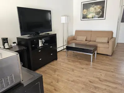 a living room with a television and a couch at H&H Motor Lodge in Idaho Springs