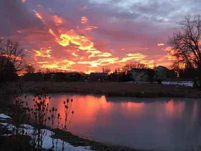 a sunset over a pond in a field at Boulder Twin Lakes Inn in Boulder
