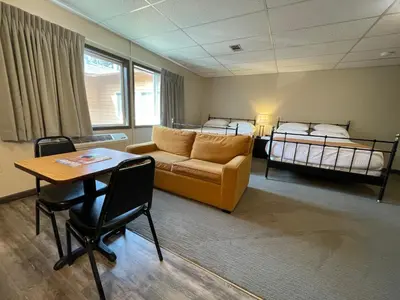a living room with a couch and a bed at Boulder Twin Lakes Inn in Boulder