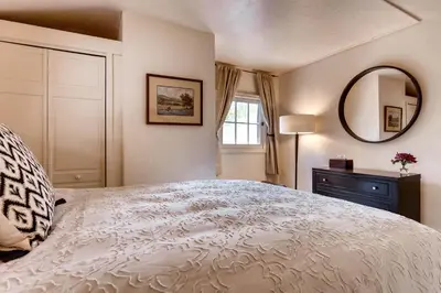 a bedroom with a large bed and a mirror at Ski Tip Lodge, A Vail Resorts Property in Keystone