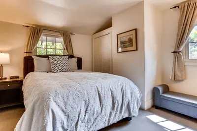 a bedroom with a bed and a blue couch at Ski Tip Lodge, A Vail Resorts Property in Keystone