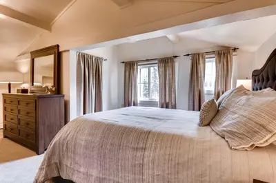 a bedroom with a large bed with a large window at Ski Tip Lodge, A Vail Resorts Property in Keystone
