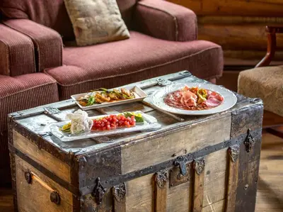 a table with two plates of food on top of a trunk at Ski Tip Lodge, A Vail Resorts Property in Keystone