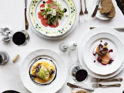 a white table with plates of food on it at Ski Tip Lodge, A Vail Resorts Property in Keystone