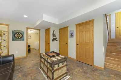 a living room with a large door and a room with a couch at Gateway to the Wildside Townhouse in Estes Park
