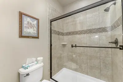 a bathroom with a shower and a toilet at Gateway to the Wildside Townhouse in Estes Park