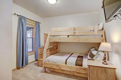 a bedroom with a bunk bed and a window at 2609 Tenderfoot Lodge Condo in Keystone